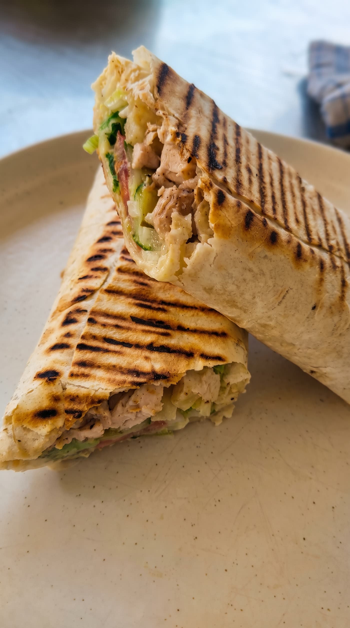 Chicken shawarma cut in half showing the filling